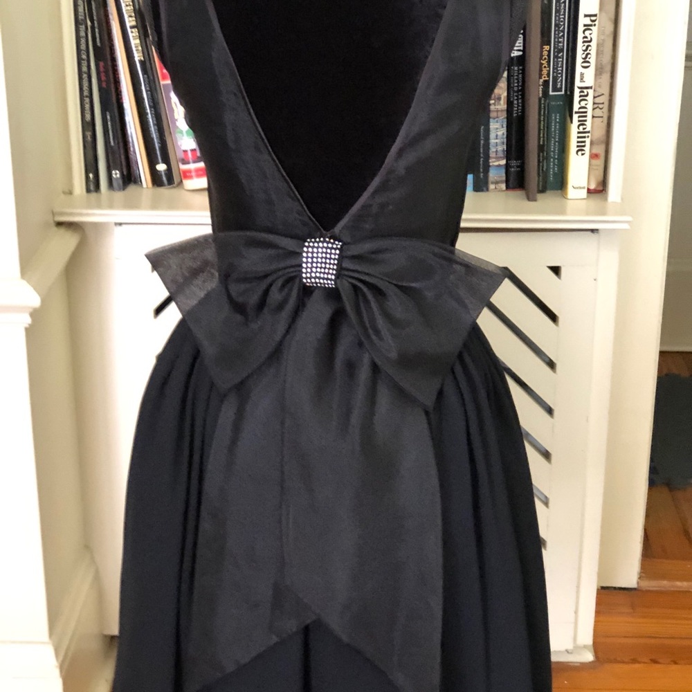 Black 1970s-style sheer bowed cocktail dress